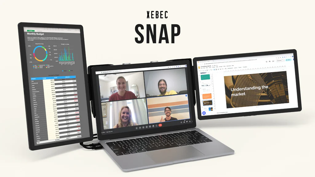 Front view of the Xebec Snap used with a MacBook Pro laptop. The laptop sits on a table with a Zoom call in progress showing on the main display. Two additional displays are attached to the main display, one on the immediate right and the other on the immediate left. The left display is mounted in a portrait orientation while the right display is in landscape. The left display shows a graph and spreadsheet of a Monthly Budget while the right display show a presentation entitled Understanding the Market. Two USB-C cables are attached the left two ports on the laptop with their cables neatly tucked behind the computer. Above the laptop and displays are the words XEBEC SNAP.